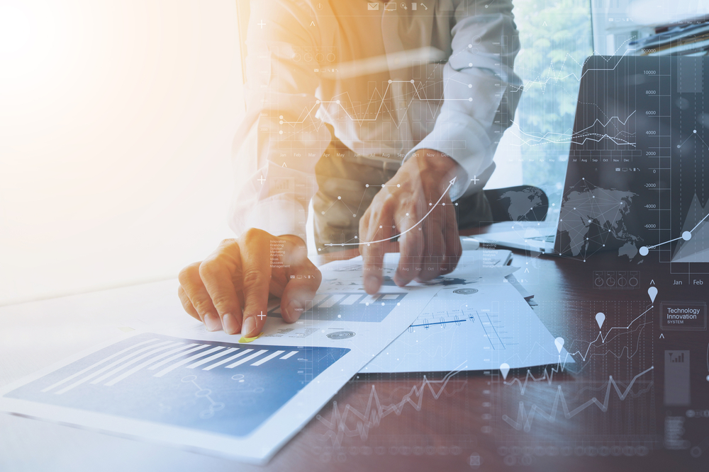 business documents on office table with smart phone and digital tablet and graph financial with social network diagram and man working in the background-2